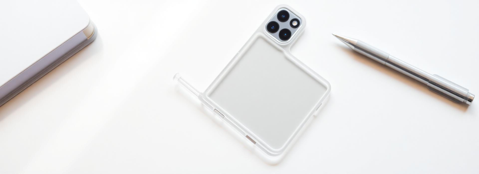 A phone case and pen on a white desk
